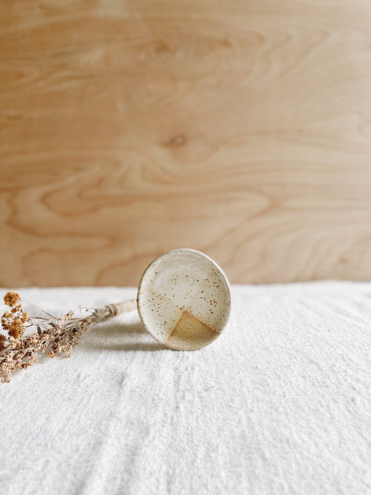 Clay blessing bowl with speckled effect.