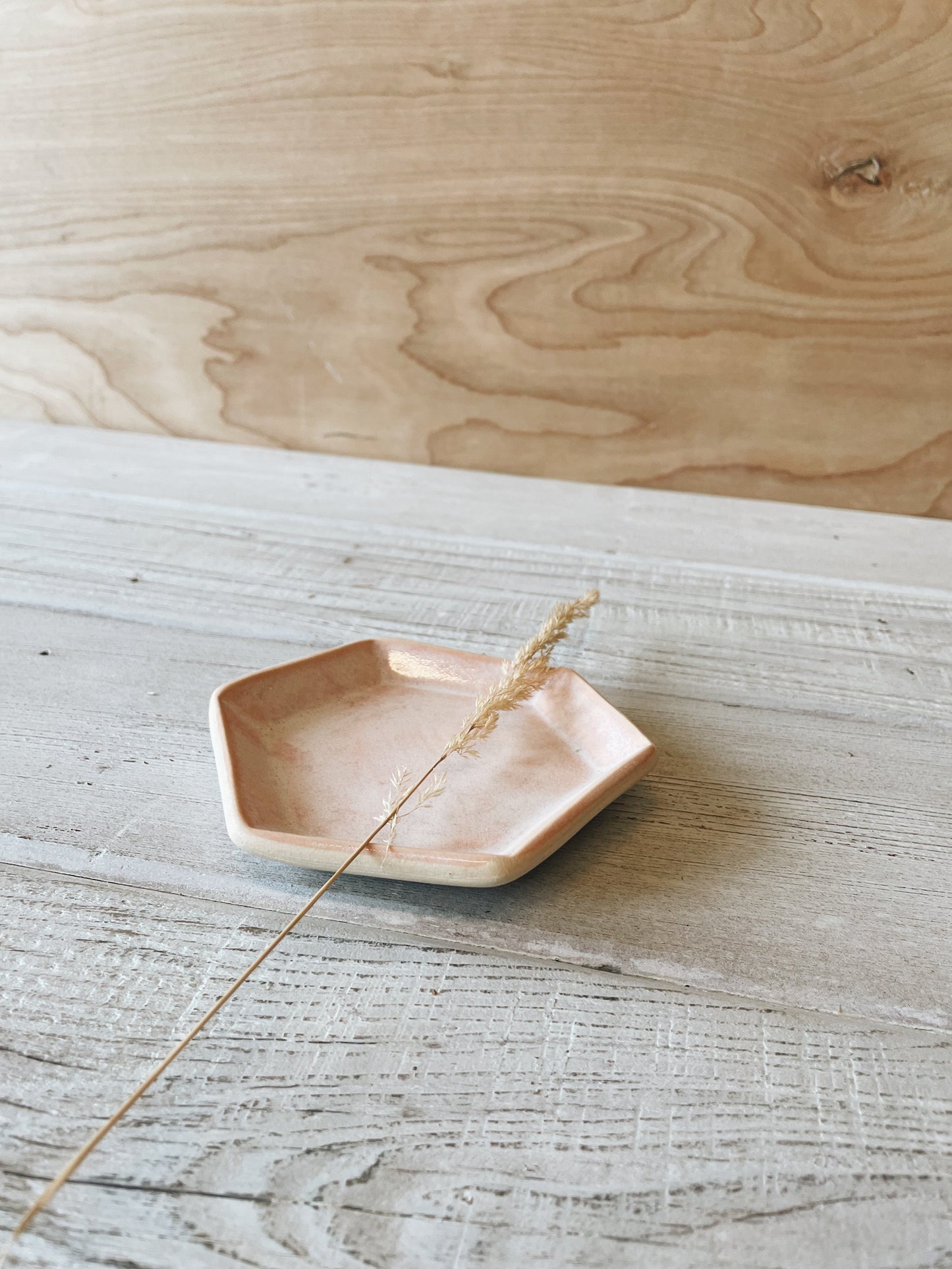 Peach hexagon ceramic dish on wooden table.